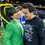 Two boys are talking to each other in the stadium.