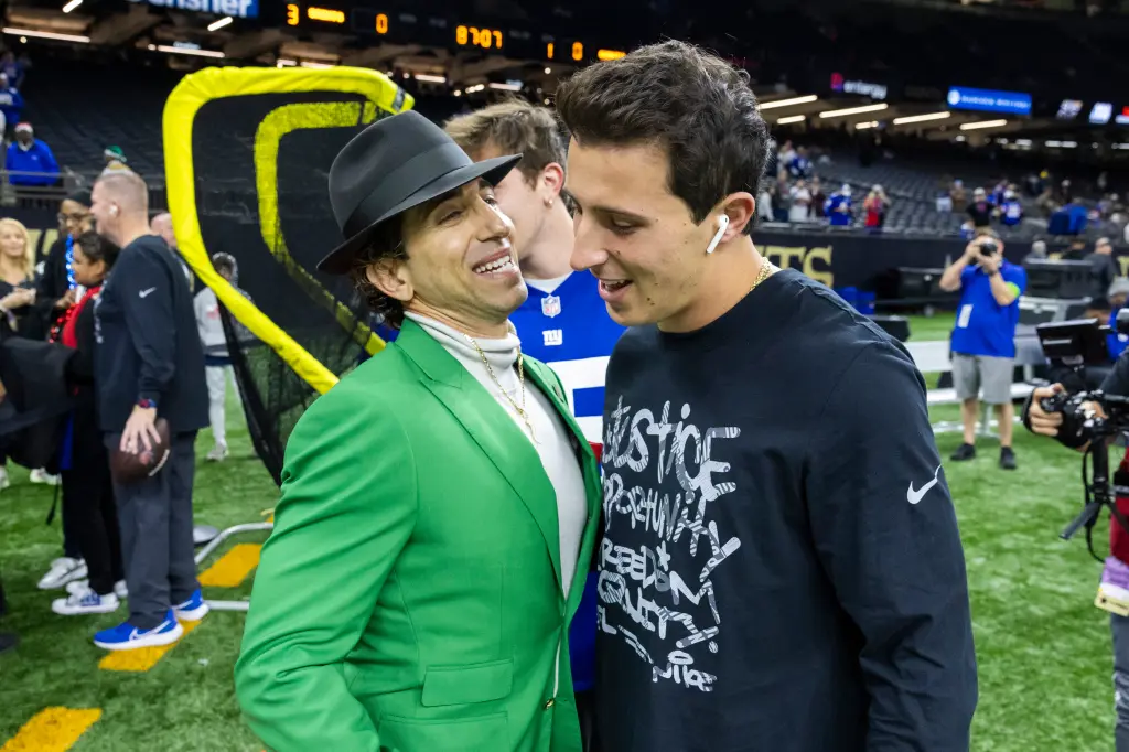 Two boys are talking to each other in the stadium.