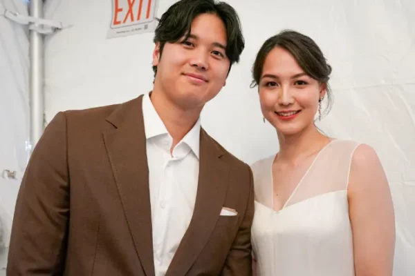 Image of Shohei Ohtani with his wife, showcasing their love and connection amidst a baseball backdrop.